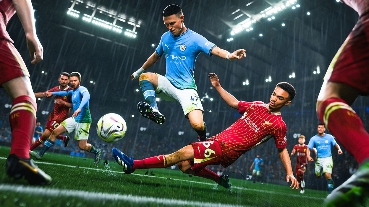 A player sliding to kick a away the ball from a player on the opposing team.